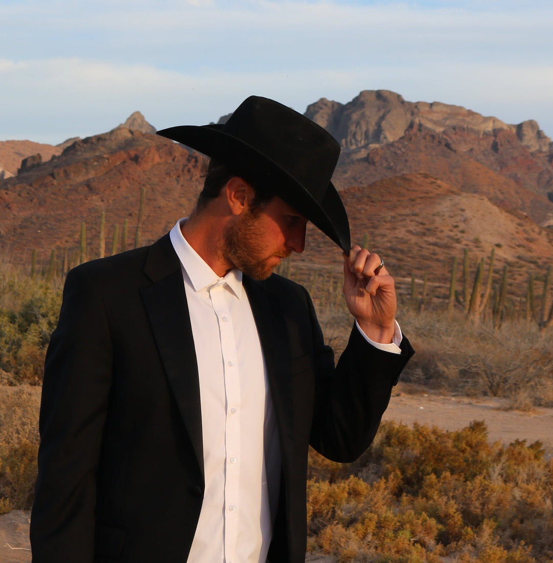 Groom and groomsmen in cowboy hats at a wedding